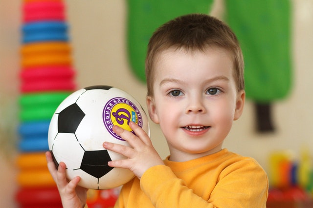 Boy with soccer ball. How does context blindness affect child with autism?