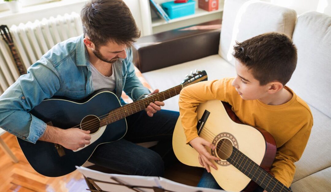 Boy taking a guitar lesson