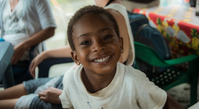 Boy smiling. Praising your child is important.