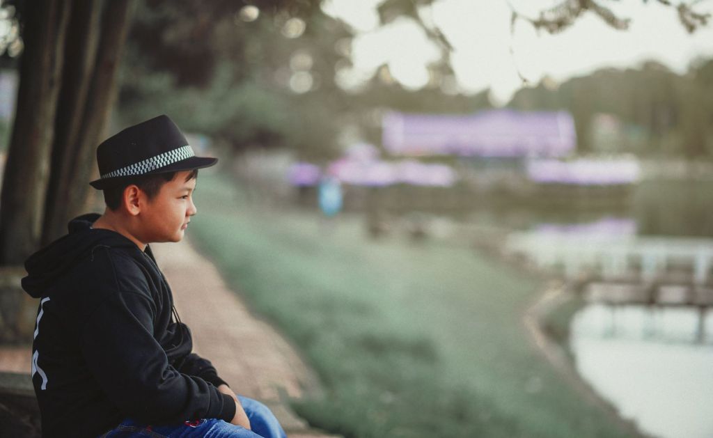 Boy sitting. Ask for support when explaining an autism diagnosis to others.