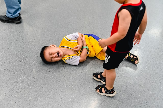 Boy crying on floor. How do autism parents deal with judgement?