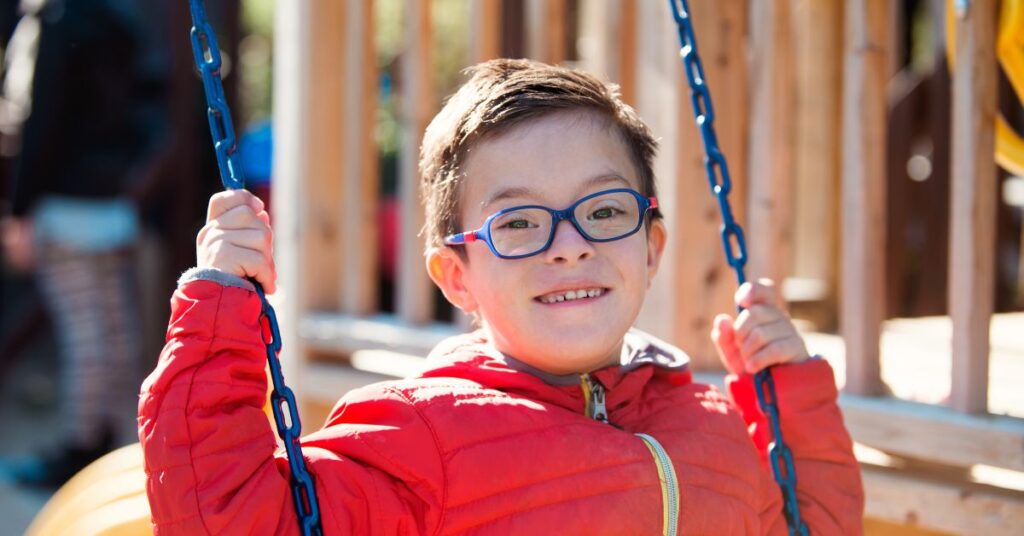 Boy with Down Syndrome swinging