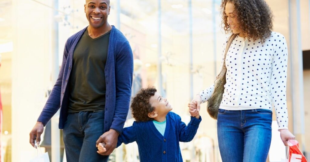 Child holding hands with parents. Prevent your child with autism from elopement.