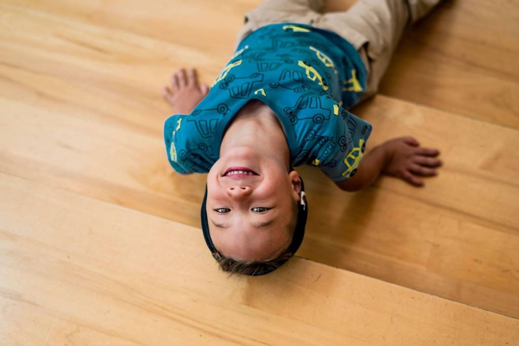 Boy lying on stairs. Help your ADHD child with impulse control.