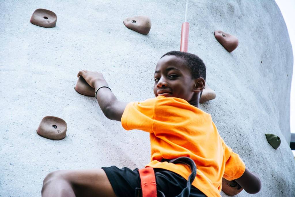 Boy rock climbing. Help your ADHD child with impulse control.