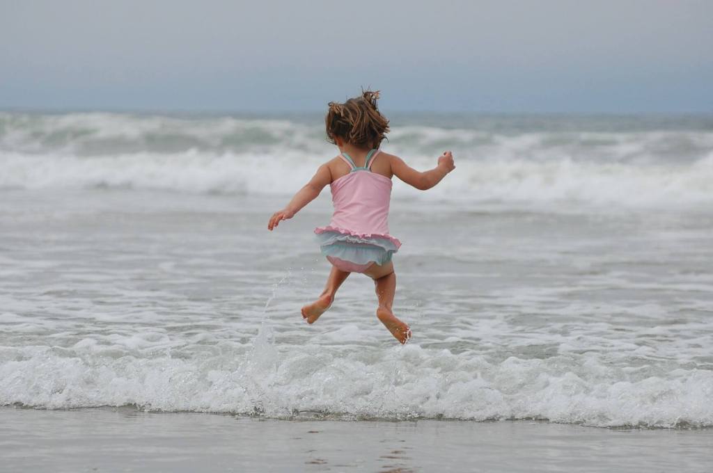 Girl jumping in water. Help your ADHD child with impulse control.