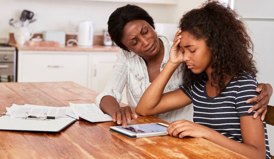 Mom sitting with teenage girl at a table