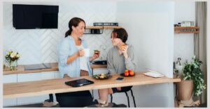 Mom and teen in the kitchen talking and eating together. Do certain foods trigger ADHD symptoms?