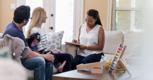 Psychologist talking to parents and child about an autism evaluation.