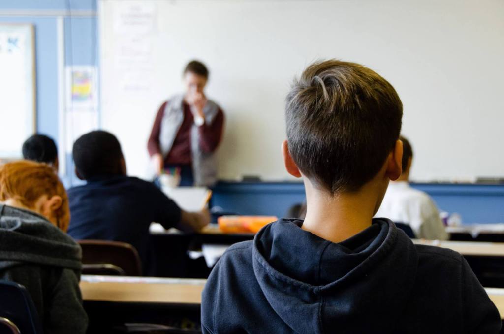 Boy in classroom. Contact your school for autism support.