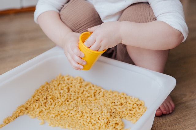 Child using a sensory box.