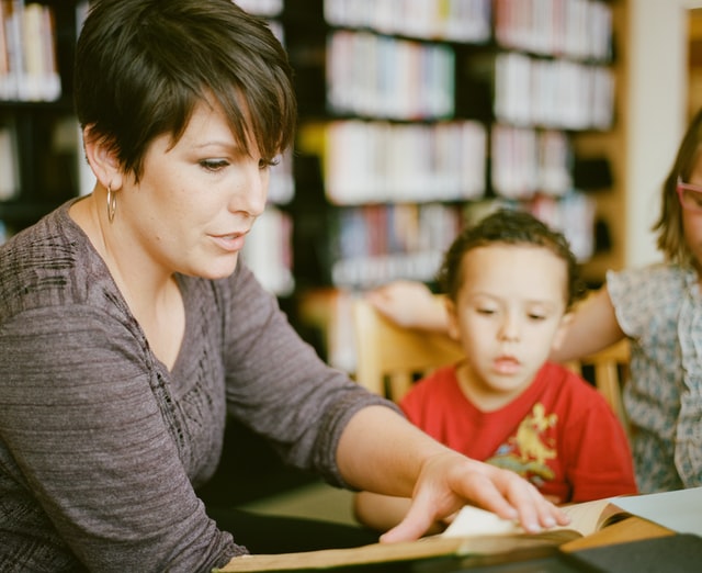 Teacher talking to boy. How to work with your autistic child's teacher.