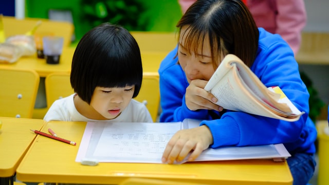 Teacher talking to girl. How to work with your autistic child's teacher.