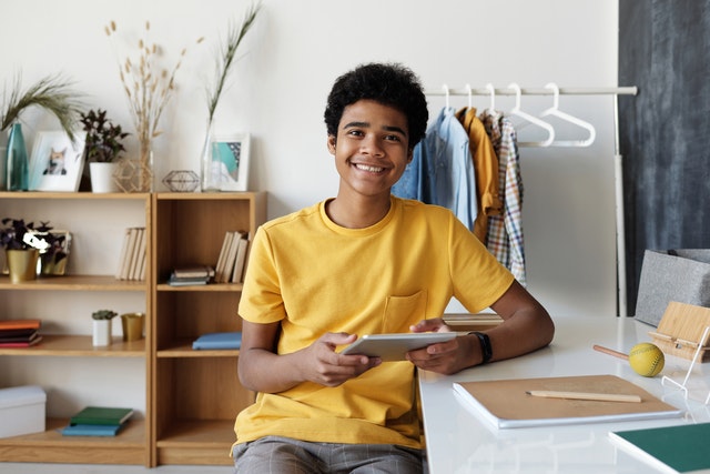 Teenage boy on iPad. Ensure Internet safety for your teen with autism.