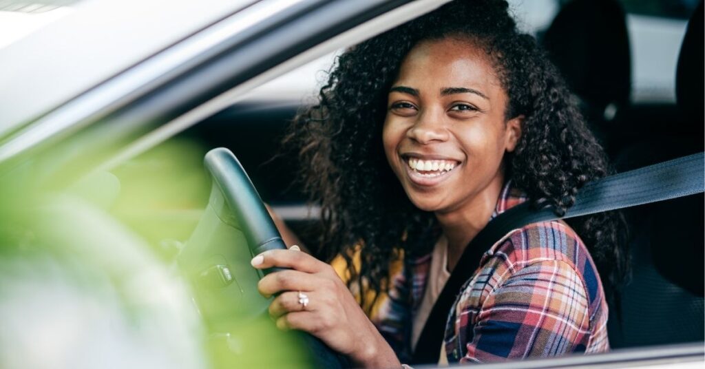 Teenage girl sitting in the driver's seat of a car. Is your teenager with autism and ADHD ready for driving?