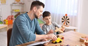 Therapist working with an autistic boy