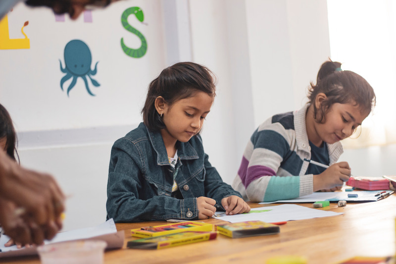 Two girls in class. Prepare your child with autism/ADHD for a new school year.