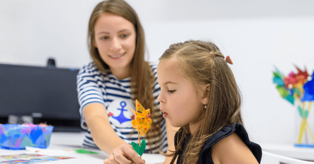 Girl blowing out in speech therapy. Support your child's speech therapy at home.